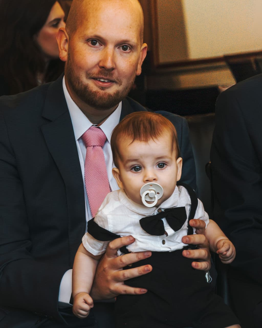 A father holding his baby before the ceremony