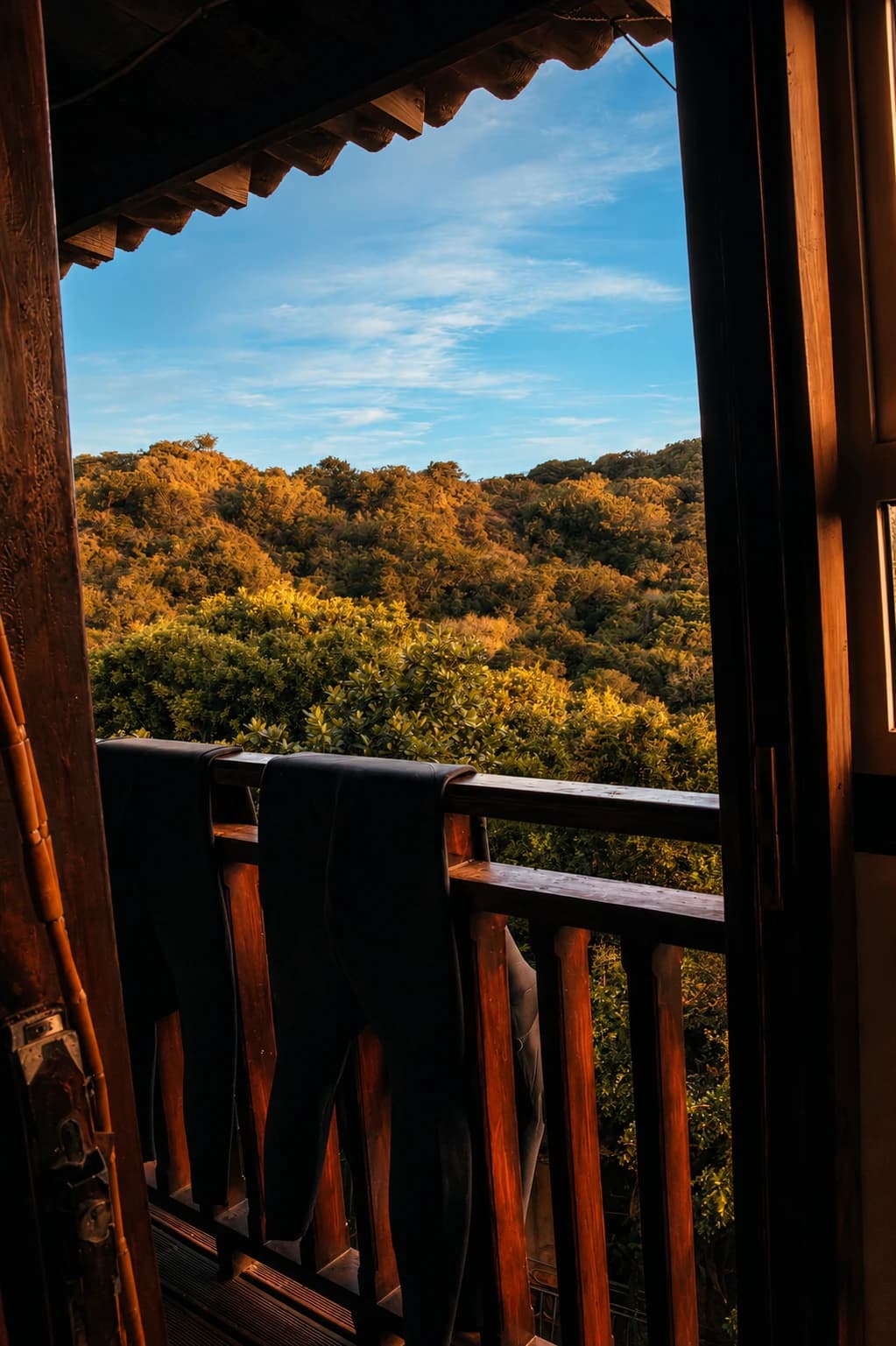 Wetsuits drying on a balcony overlooking the Eastern Cape hills