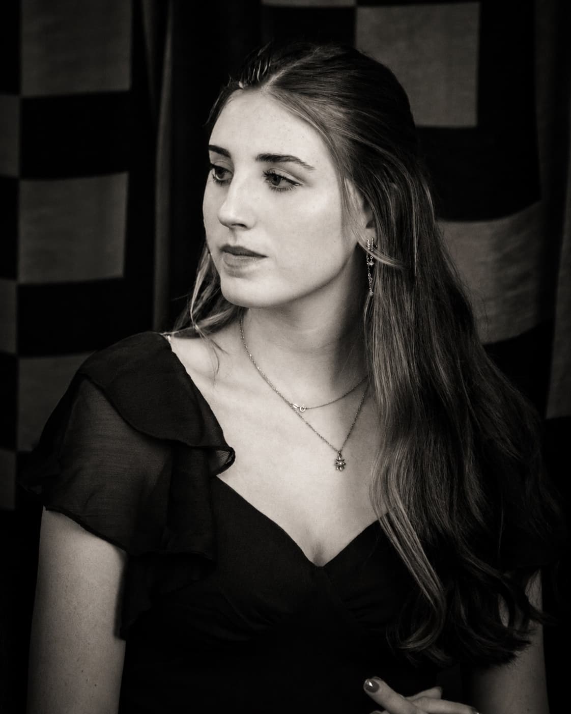 A woman in a black dress, watching — a quiet moment before the ceremony