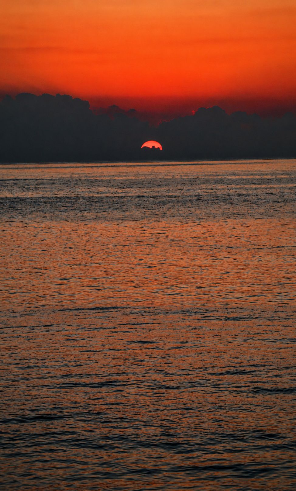 Warm golden light on ocean surface, abstract