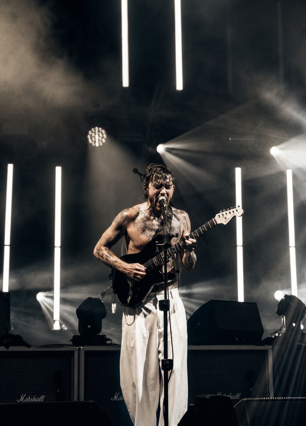 Concert performer on stage with dramatic lighting