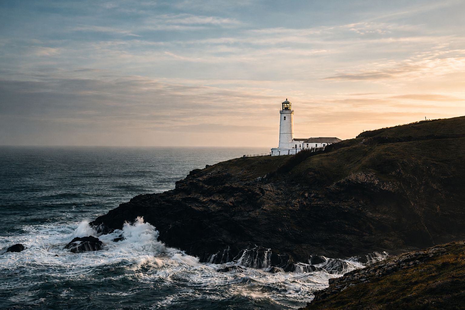 Trevose Lighthouse at golden hour, waves crashing below